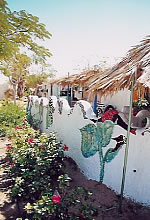Kibbutz Lotan in the Arava adds environmentalism to the ideological legs of the kibbutz movement. This wall is made from recycled materials.