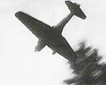 Japanese aircraft (possibly a D3A Val or Ki-27 Nate) attacking an allied position.