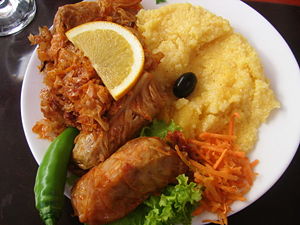 A plate of sărmăluţe cu mămăligă, a popular Romanian dish.