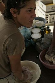 A Creek U.S. Army soldier preparing frybread during a 2004 pow-wow in Iraq.