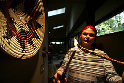 A woman lights a smudge stick made of lavender.