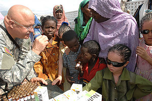 U.S. Army Sgt. 1st Class Charles F. Parnell, from Combined Joint Task Force - Horn of Africa, administers medicine and vitamins to villagers in Sagallou, Djibouti, Jan. 24, 2007.(Dept. of Defense image.)