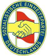 The logo of the Socialist Unity Party. The SED emblem represented the handshake between Communist Wilhelm Pieck and Social Democrat Otto Grotewohl when their parties merged in 1946.