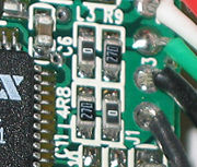 This image shows four surface-mount resistors (the component at the upper left is a capacitor) including two zero-ohm resistors. Zero-ohm links are often used instead of wire links, so that they can be inserted by a resistor-inserting machine.