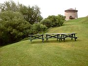 Picnic tables and Martello Tower in The Battlefields Park