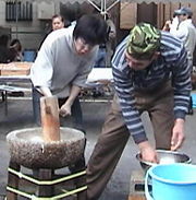 Pounding mochi in an usu.