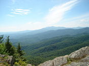 The Blue Ridge Mountains in the foreground with Grandfather Mountain in the extreme background as seen from Blowing Rock, NC.