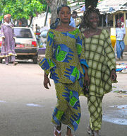 Women in native attire walking in Conakry.