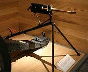 A modern image of an 1895 tripod-mounted, .303 caliber Maxim machine gun. The original Maxim of the 1880s was the first fully automatic machine gun, as well as using a a belt of linked ammunition rather than a hopper