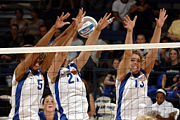 Three players performing a block