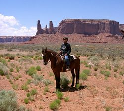 Contemporary Navajo boy riding horseback in Monument Valley, Arizona