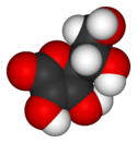 A three-dimensional model of an ascorbic acid molecule. Black represents carbon; red, oxygen; and white, hydrogen.