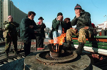 Dudayev's supporters pray in front of the Presidential Palace in Grozny, 1994. Photo by Mikhail Evstafiev