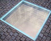 Monument to the May 10, 1933, Book burning: Empty bookshelves, enough to hold all 20,000 burned books, visible below the pavement of Bebelplatz