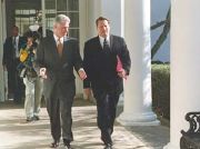 Vice President Gore with President Bill Clinton walking along a colonnade at the White House.
