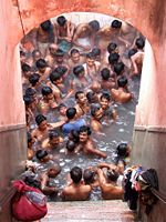 Hindu Devotees bathing in the Lakshmi Narayan Mandir.
