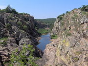 A river carves a canyon in the Wichita Mountains.