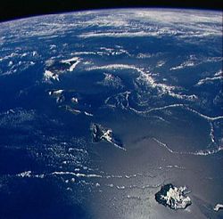 Photograph of the Hawaiian Islands from space shuttle Discovery, looking southeast by south. Kaua‘i is closest at bottom right