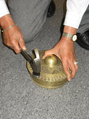 Tongkol process using a hammer to tune the gongs.