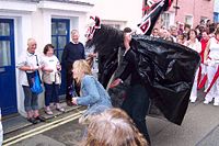 The Old 'Oss capturing a passing maiden during the Mayday festival.