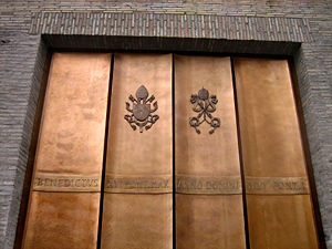 Example of public art under current pontificate: a new gate to Vatican City. Benedictus XVI Pont(ifex) Max(imus) Anno Domini MMV Pont(ificatus) I. Benedict XVI, Supreme Pontiff, in the year of Our Lord 2005, in the first year of his pontificate.