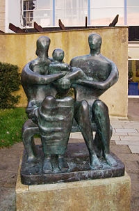 Henry Moore, Family Group (1950), bronze, sited at the entrance to Barclay School, Stevenage, Hertfordshire, England.
