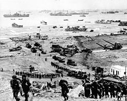 The build-up of Omaha Beach: reinforcements of men and equipment moving inland during the invasion of Normandy.