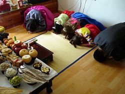 Bowing to the ancestors as part of a Jesa, a Confucian ritual.