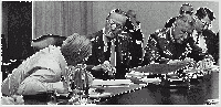 President Johnson (turned away from the camera) in conversation with Chairman of the Joint Chiefs of Staff Earle Wheeler (l) and General Creighton Abrams (r)