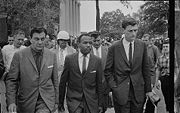 James Meredith walking to class accompanied by U.S. marshals