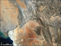 This image shows only the last 100 km of the Orange River, a stretch where the gravel deposits in the river bed and along the banks are rich with diamonds; several diamond mines operate here.
