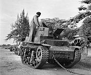 A soldier of an Indian armoured regiment examines a light tank used by Indonesian nationalists and captured by British forces during the fighting in Surabaya.
