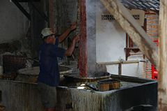 Dipping a cloth in a dye.