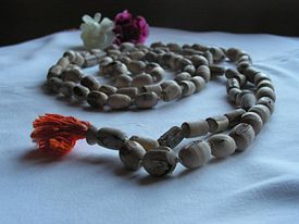 Set of Japa mala, made from Tulasi wood, with head bead in foreground.