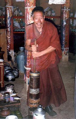 A monk churning butter tea.