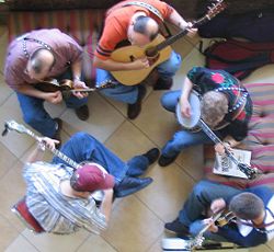 Bluegrass jam session. Note the acoustic musical instruments, guitar, mandolins and banjos