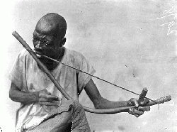 Obu man playing a musical bow