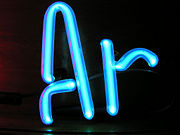 An argon-filled discharge tube glows brightly when an electric current is passed through it.
