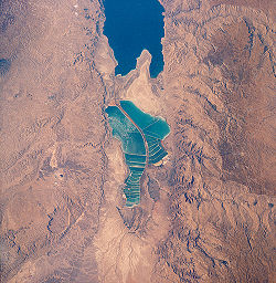 View of salt evaporation pans on the Dead Sea, taken in 1989 from the Space Shuttle Columbia. The southern half is now separated from the northern half at what used to be the Lisan Peninsula due to the fall of the level of Dead Sea.