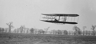 Orville in flight over Huffman Prairie, in Wright Flyer II. Flight #85, approximately 1,760 ft in 40 1/5 seconds, Nov. 16, 1904.