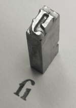 A piece of cast metal type, Garamond style long s / i ligature.