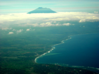 An aerial view of Bali's eastern coast, with Mount Agung in the background.