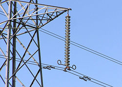 Cap and pin insulator string (the vertical string of discs) on a 275 kV suspension pylon.