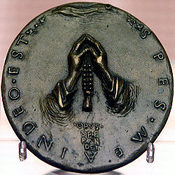 A devotional medal made of bronze.