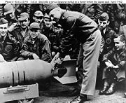 Lt Col James H. Doolittle, USAAF (front), leader of the raiding force, wires a Japanese medal to a 500-pound bomb, during ceremonies on the flight deck of USS Hornet (CV-8), shortly before his force of 16 B-25B bombers took off for Japan. The planes were launched on April 18, 1942.