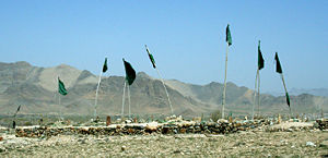 Green flags, the color of Islam, mark a graveyard in southeast Afghanistan.