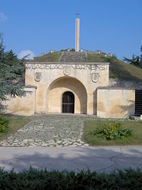Memorial of the Battle of Varna of 1444 carved into an ancient Thracian burial mound. The sign in front is for Władysław III of Poland