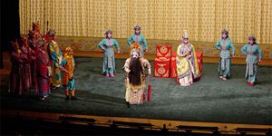 Ensemble cast, with lead character in classic make-up and costume. In this story the King wishes to make the princess (right of king) one of his wives, but she secretly loves the rebel warrior prince (left at head of group)