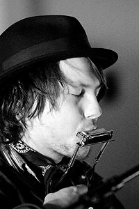 A harmonica played in a neck rack, allowing the musician to play the guitar at the same time.