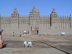 The Great Mosque's signature trio of minarets overlook the central market of Djenné. Unique Malian aesthetic